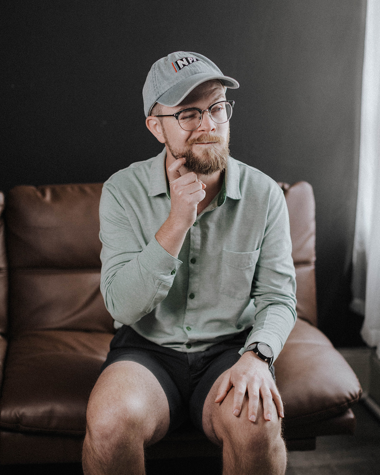 Image of Matt Headland, a Google Ads specialist for therapy practices, scratching chin and making a silly face, wearing a light blue hat and a light green long sleeve button down polo shirt.